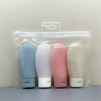 Flacons de voyage souples - lot de 4 flacons dans leur trousse transparente