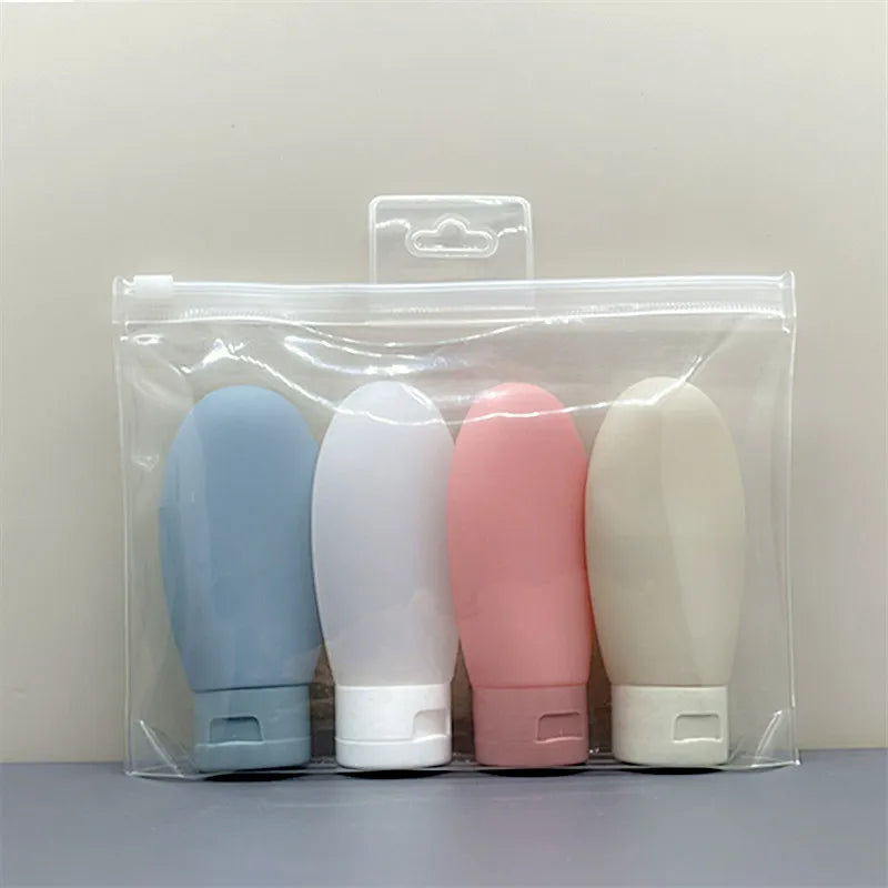 Flacons de voyage souples - lot de 4 flacons dans leur trousse transparente